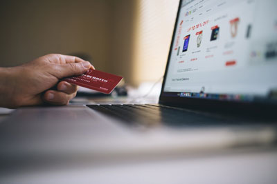 Using a credit card while shopping an eCommerce site on a laptop