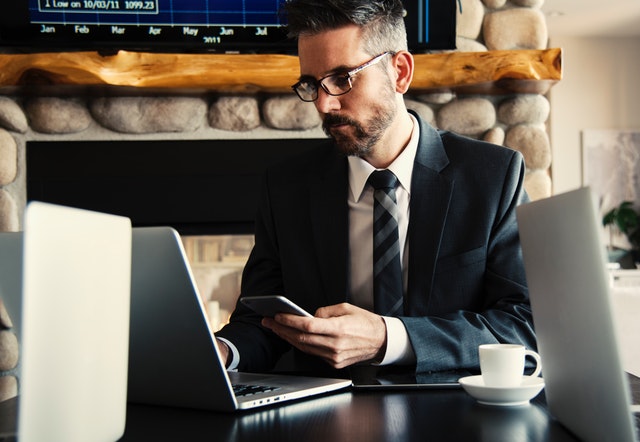 Business owner suing CRM software on his laptop